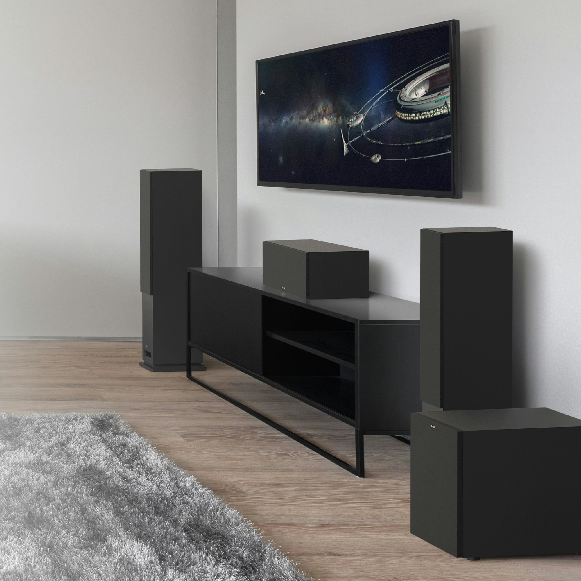 KD Series tower system with grilles on and a black credenza in a living room setting